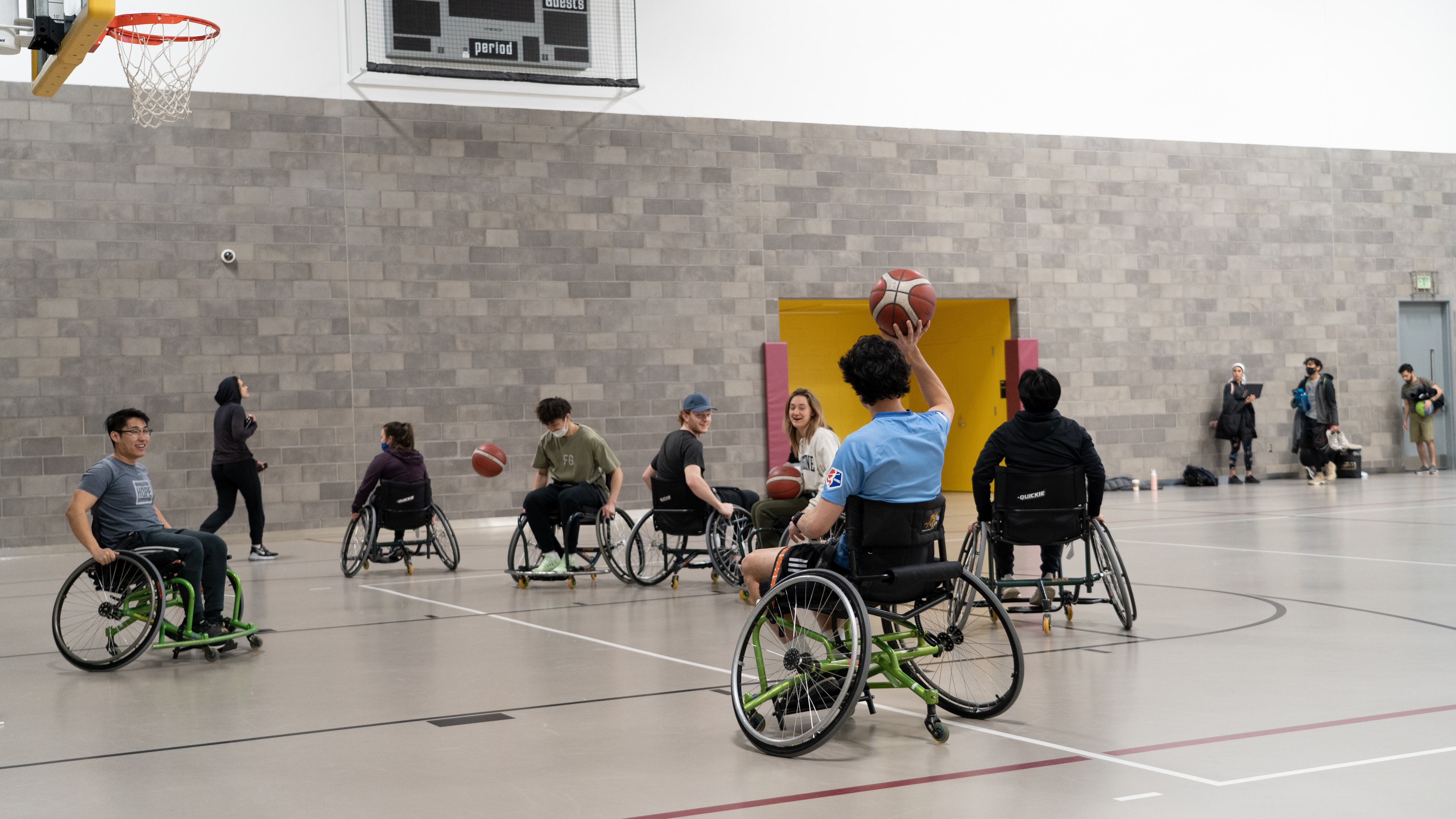student playing wheelchair basketball starting to throw ball
